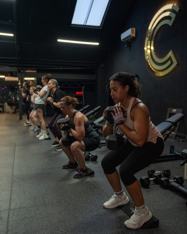 A class training together under the signage