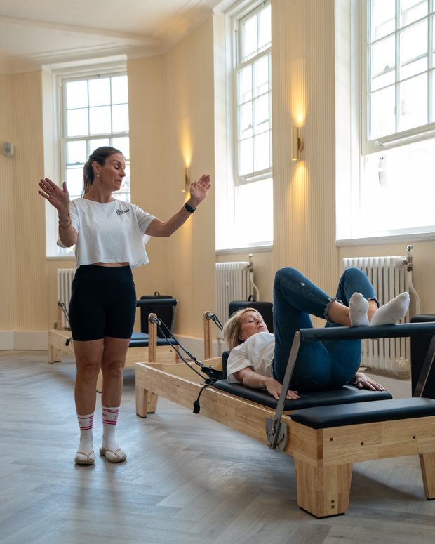 Reformer class in a sunlit studio
