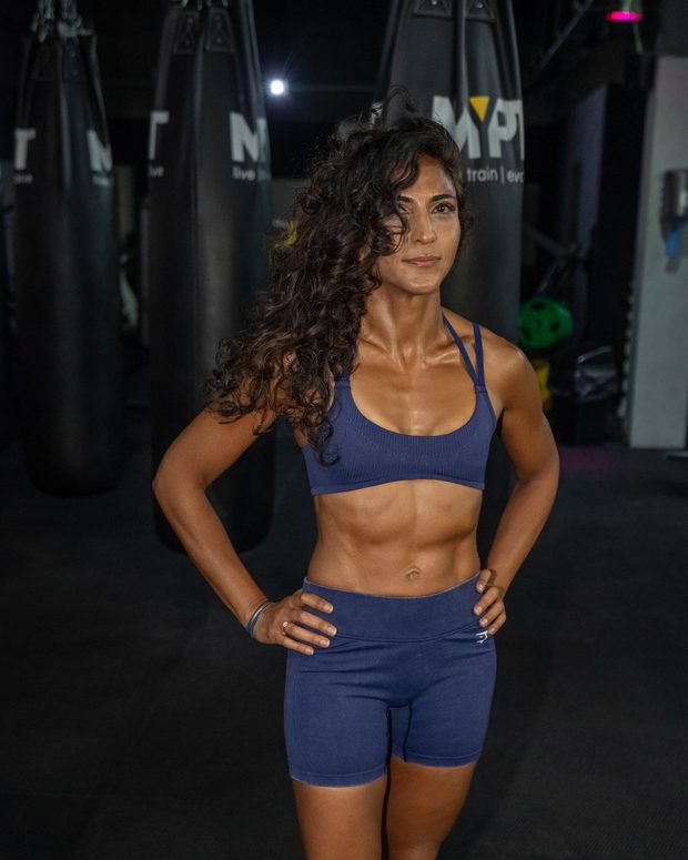 Trainer portrait in front of the punch bags